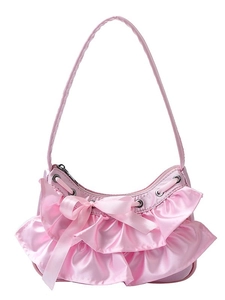 Pink satin hobo bag featuring feminine ruffles and a silk bow on white background