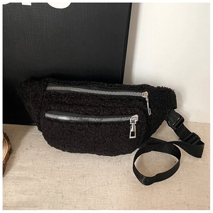 Close-up of black teddy fleece waist bag with double silver zippers and adjustable strap