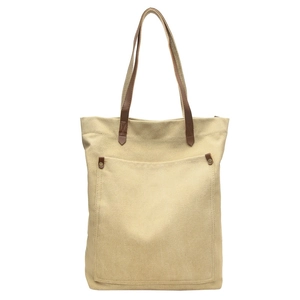 Minimalist beige canvas tote bag with brown leather handles and front pocket detail