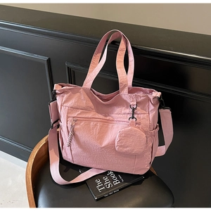 Detailed view of pink nylon tote bag with matching round pouch and side pockets