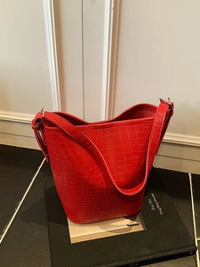 Classic red crocodile pattern bucket bag with adjustable shoulder strap and glossy finish