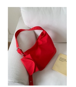Detail of red canvas hobo bag with mini pouch and silver metal adjustment buckle