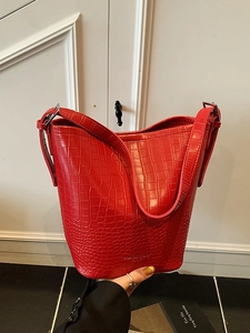 Classic red crocodile pattern bucket bag with adjustable strap and silver hardware
