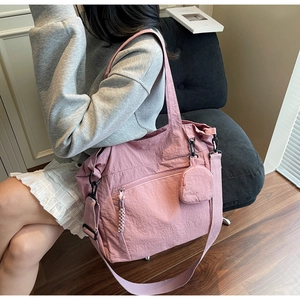 Detailed macro of pink nylon tote bag texture with side pocket and mini coin purse
