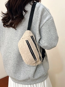 Beige teddy fleece crossbody chest bag with adjustable strap worn on grey sweatshirt