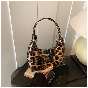 Detail of leopard print patent leather bag with silver chain strap and zipper close