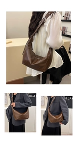 Detail view of brown dumpling shoulder bag with wide strap on a female model