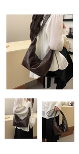 Detailed view of dark brown crescent shoulder bag with minimalist geometric stitching