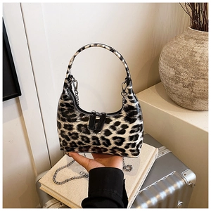 Detailed view of leopard print semi-moon handbag with silver chain and dual zippers