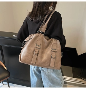 Detailed view of khaki large tote bag featuring textured PU leather and metallic hardware