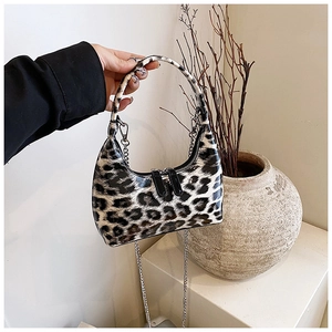 Detail of the glossy patent leather leopard print texture on this chic half-moon handbag