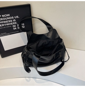 Detail view of the spacious interior of a black PU leather tote bag with zipper closure
