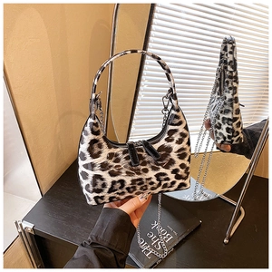 Detail of leopard print handbag with glossy finish, silver chain strap and dual zippers