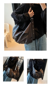 Detail view of large dark brown retro tote bag with silver star rivets and wide strap
