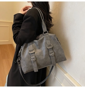 Detail of grey large capacity tote bag with vintage texture and stylish shoulder straps
