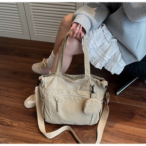 Detailed macro view of beige nylon tote bag texture with round hanging coin purse