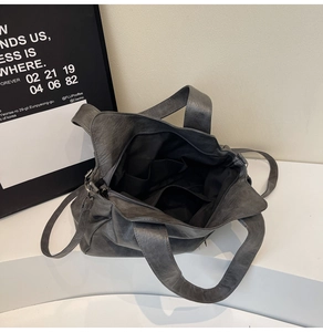 Internal view of the grey tote bag showing spacious compartments and inner pockets