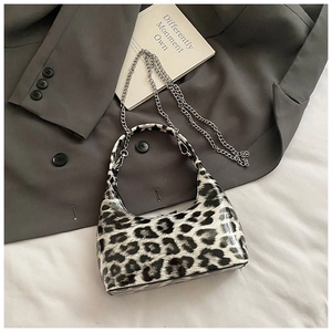 Chic leopard print half-moon bag featuring glossy finish and detachable silver chain strap