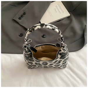 Top view of leopard print handbag with zipper closure and smooth interior pocket