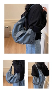 Detail view of grey-blue motorcycle style tote bag with silver star rivets and soft texture