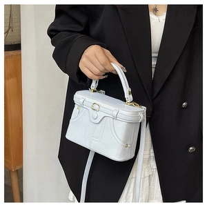 Structured ice blue square box bag with vintage pocket stitching and adjustable strap