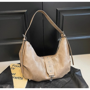 Detail view of khaki faux leather tote bag with star rivets and vintage wrinkled texture