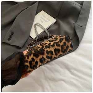 Detail shot of leopard print handbag with silver chain strap and velvet texture fabric