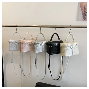 Detail view of mini denim box bags in five colors with metal buckles and long straps
