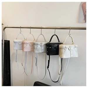 Row of vintage box bags in white, pink, silver and black with metallic hardware details