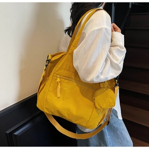 Detail of yellow nylon tote bag with side pocket and matching small round coin purse