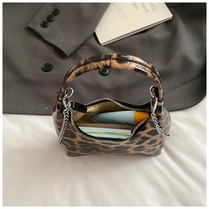Leopard print hobo bag with silver chain showing interior capacity for cosmetics