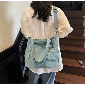 Nylon tote bag detail showing large capacity, Morandi blue texture, and adjustable strap