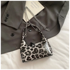 Detail of hobo handbag with leopard pattern and polished silver metal chain strap