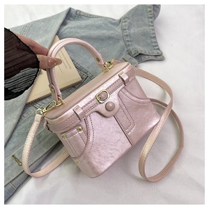 Detailed view of pink box bag with vintage gold hardware and textured faux leather finish