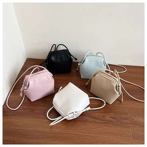 Group shot of shell-shaped crossbody bags in five colors with lychee grain texture
