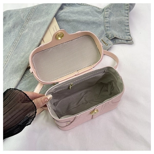 Detailed interior of a pink box bag showing a zip pocket and magnetic closure
