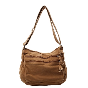 Brown multi-pocket canvas crossbody bag with adjustable wide shoulder strap for daily use