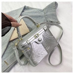 Detailed close-up of metallic silver PU box bag featuring denim-style stitching and hardware