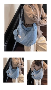 Detail of light blue denim hobo bag with vintage label and detachable small coin pouch charm