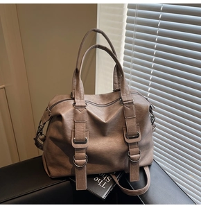 Macro view of vintage brown leather texture and metal buckles on the large tote bag