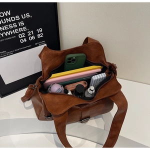 Interior view of brown leather shoulder bag showing large capacity for everyday items