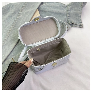 Top view showing the spacious interior, grey lining, and zipper pocket of the denim box bag