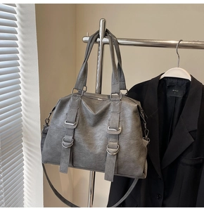 Detailed macro view of dark grey textured tote bag with silver ring buckle and handle