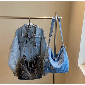 Detailed comparison of vintage washed denim crossbody bags in dark grey and light blue tones