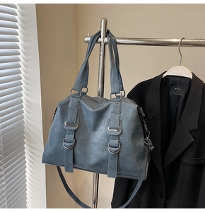 Close-up of Morandi blue tote bag featuring litchi grain leather and silver hardware detail