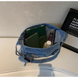 Internal view of a large denim tote bag showing space for a tablet, phone, and water bottle