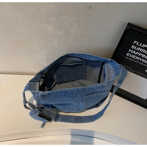 Macro shot showing the interior pocket and spacious main compartment of denim tote bag