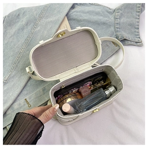 Top view of white box bag interior showing Herringbone lining and spacious storage