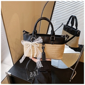 Detail of woven tote bag with lace bow, pearl beads and elegant leather handles