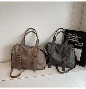 Close-up of vintage tote bags with textured finish, metal rings, and dual straps
